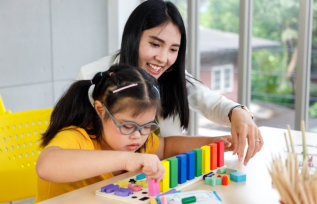 care assistant and child smiling