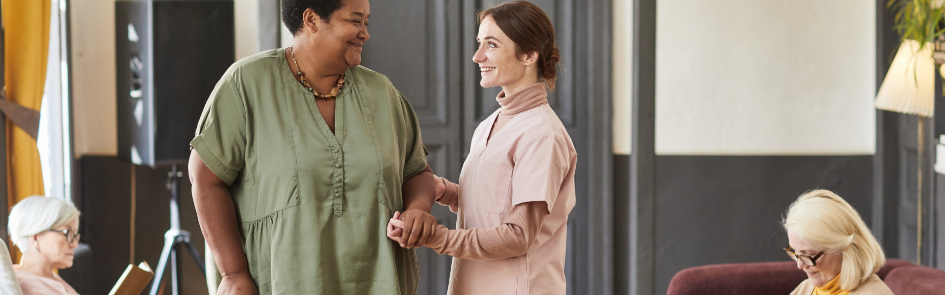 nurse assisting an elderly woman