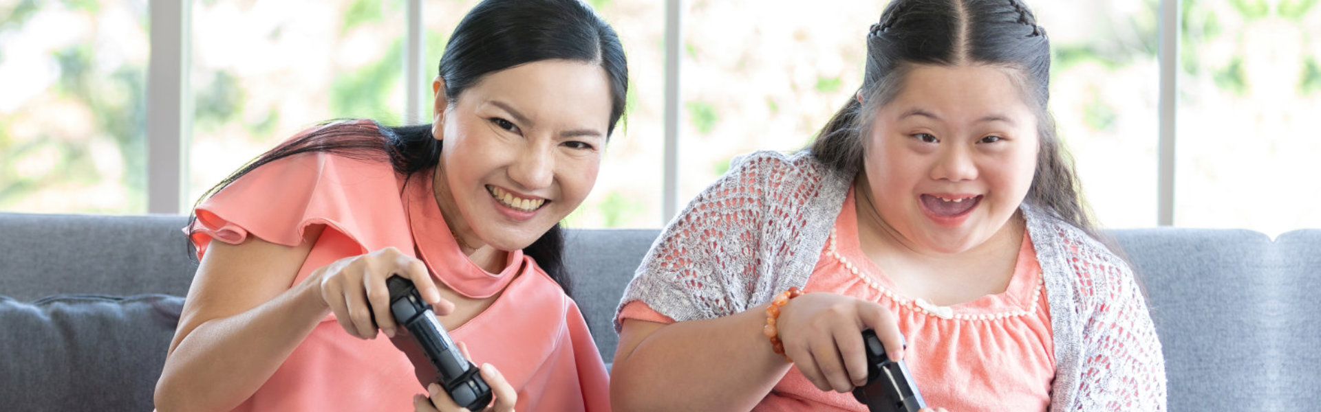 two women playing with a console